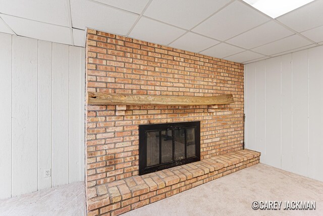 3910 Walker Ave NW, Grand Rapids, MI 49544 - detailed view of a drop ceiling, carpet floors, a brick fireplace, and wooden walls
