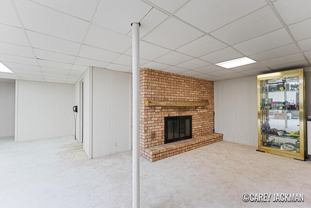 3910 Walker Ave NW, Grand Rapids, MI 49544 - below grade area featuring a paneled ceiling, carpet, and a fireplace