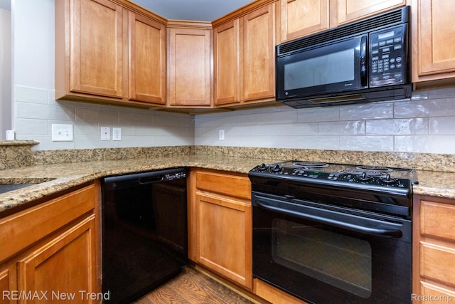 45929 Graystone Ln, Canton, MI 48187 - kitchen with black appliances, backsplash, light stone countertops, and wood finished floors