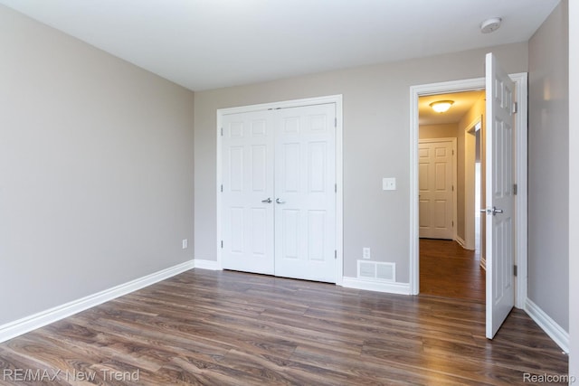 45929 Graystone Ln, Canton, MI 48187 - unfurnished bedroom featuring dark wood-style floors and a closet