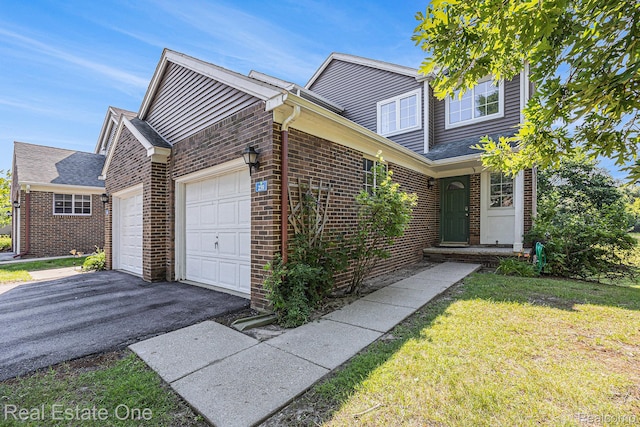 239 Fieldcrest St, Ann Arbor, MI 48103 - view of front of property with an attached garage, brick siding, driveway, and a front yard