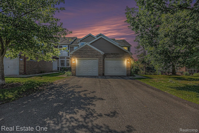 239 Fieldcrest St, Ann Arbor, MI 48103 - view of front of property with asphalt driveway, brick siding, an attached garage, and a front lawn