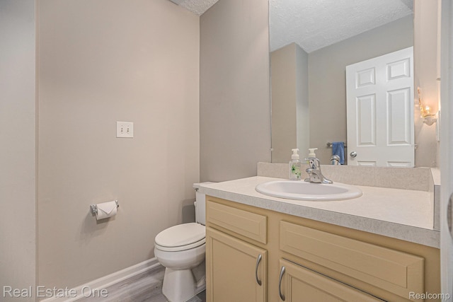 239 Fieldcrest St, Ann Arbor, MI 48103 - bathroom featuring vanity, wood finished floors, and a textured ceiling