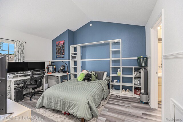 239 Fieldcrest St, Ann Arbor, MI 48103 - bedroom featuring vaulted ceiling, wood finished floors, and an office area