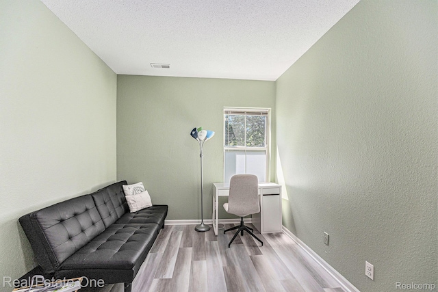 239 Fieldcrest St, Ann Arbor, MI 48103 - office featuring wood finished floors, a textured ceiling, and a textured wall