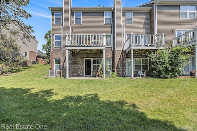 239 Fieldcrest St, Ann Arbor, MI 48103 - rear view of property featuring brick siding and a lawn