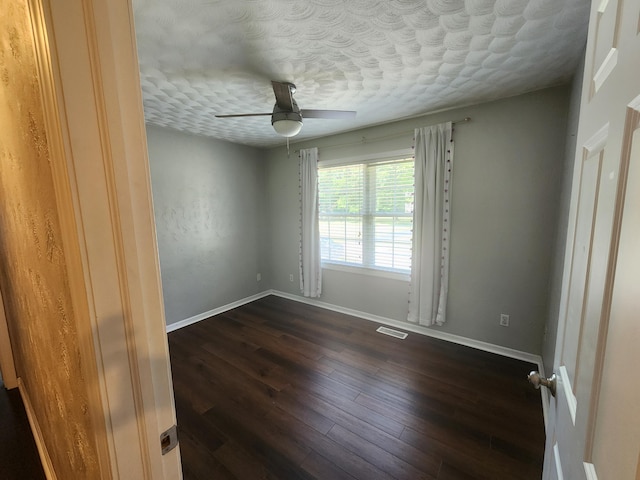 8270 Robins Ln, Battle Creek, MI 49014 - unfurnished room featuring a ceiling fan, dark wood-style floors, and a textured ceiling