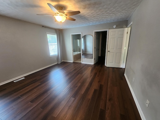 8270 Robins Ln, Battle Creek, MI 49014 - unfurnished bedroom with dark wood-style floors, ensuite bath, and a ceiling fan