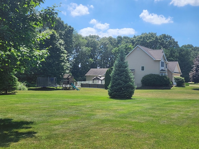 8270 Robins Ln, Battle Creek, MI 49014 - view of green lawn with a playground and a trampoline