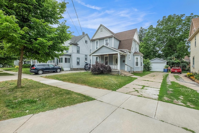 1607 Center Ave NE, Grand Rapids, MI 49505 - view of front of home with covered porch, an outbuilding, a garage, a front lawn, and roof with shingles