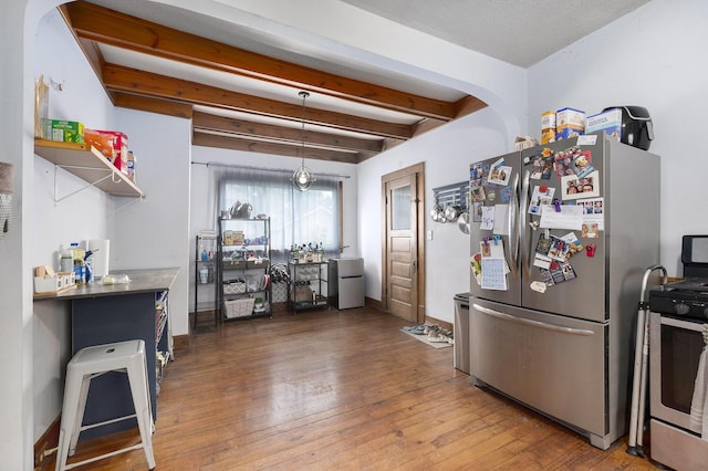 1607 Center Ave NE, Grand Rapids, MI 49505 - kitchen with stainless steel appliances, beamed ceiling, hardwood / wood-style floors, and open shelves