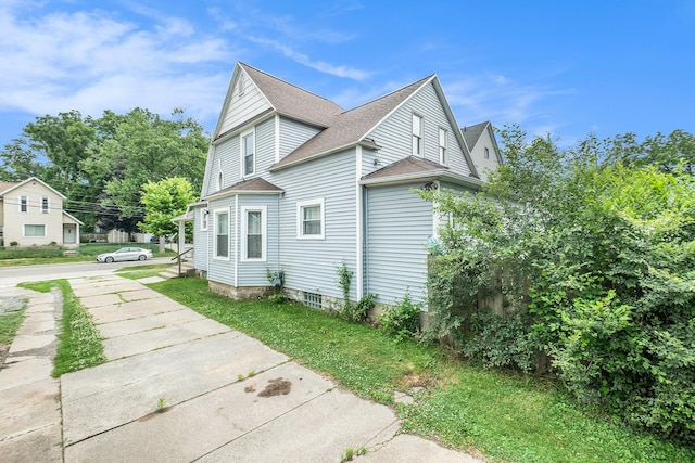 1607 Center Ave NE, Grand Rapids, MI 49505 - view of side of property featuring roof with shingles