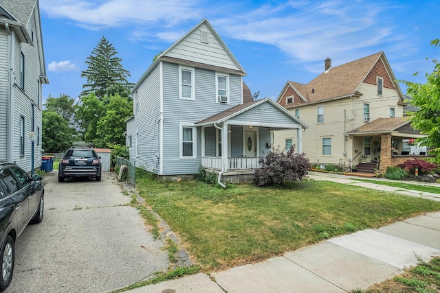 1607 Center Ave NE, Grand Rapids, MI 49505 - view of front facade featuring covered porch and a front lawn