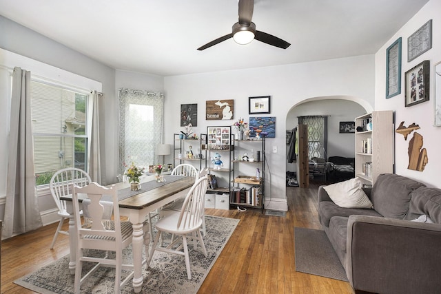 1607 Center Ave NE, Grand Rapids, MI 49505 - dining area featuring arched walkways, a ceiling fan, and wood finished floors