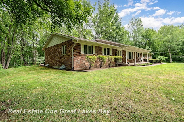 13840 Dice Rd, Hemlock, MI 48626 - single story home featuring a front yard, brick siding, and covered porch