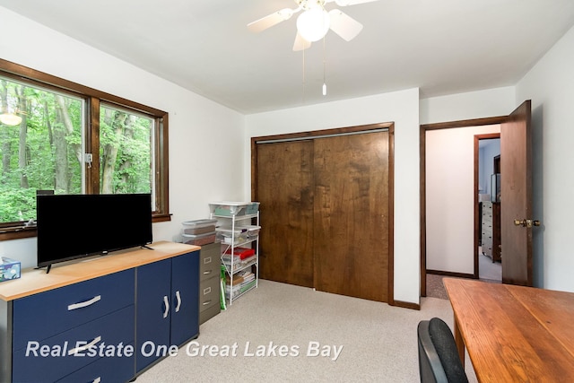 13840 Dice Rd, Hemlock, MI 48626 - bedroom with light colored carpet, a closet, a desk, and ceiling fan