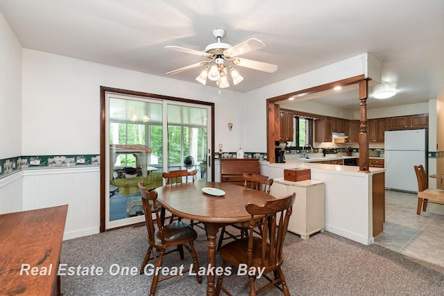 13840 Dice Rd, Hemlock, MI 48626 - dining room featuring healthy amount of natural light, a wainscoted wall, ceiling fan, and light carpet