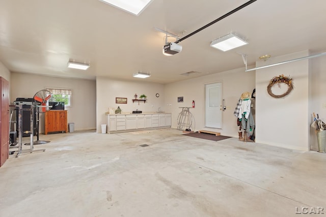 3224 Sand Creek Highway, Adrian, MI 49221 - garage featuring a garage door opener and a sink