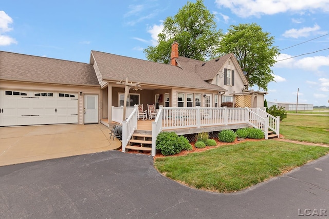 3224 Sand Creek Highway, Adrian, MI 49221 - view of front facade featuring concrete driveway, a front yard, a garage, a chimney, and a wooden deck