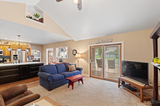 3224 Sand Creek Highway, Adrian, MI 49221 - living room with light colored carpet, high vaulted ceiling, ceiling fan, and a chandelier