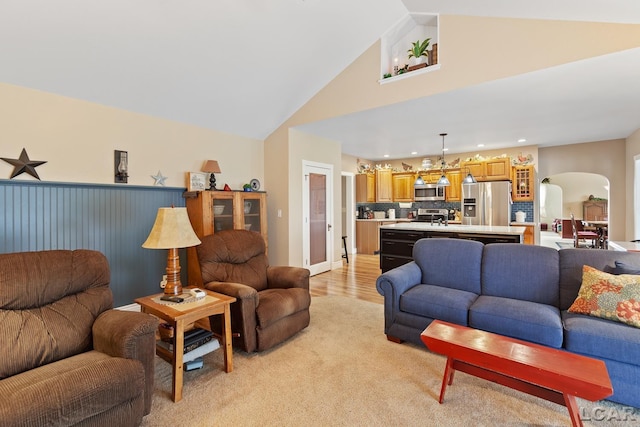 3224 Sand Creek Highway, Adrian, MI 49221 - living area with arched walkways, recessed lighting, light carpet, and high vaulted ceiling