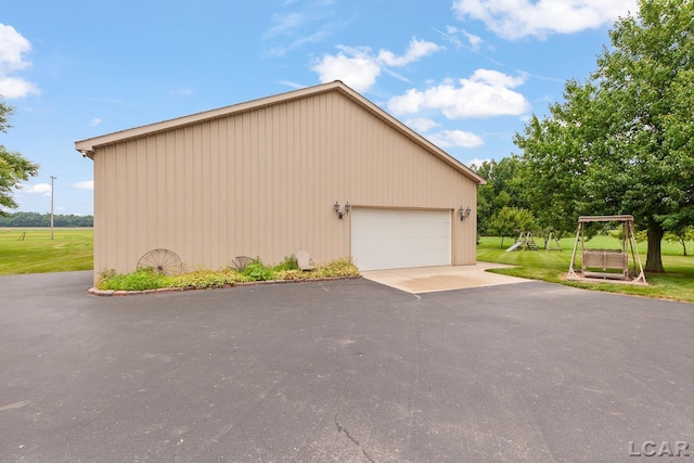 3224 Sand Creek Highway, Adrian, MI 49221 - view of property exterior featuring a detached garage, a lawn, and an outbuilding