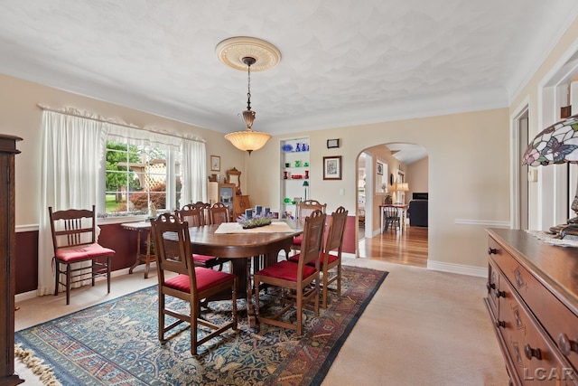 3224 Sand Creek Highway, Adrian, MI 49221 - dining area featuring arched walkways and light colored carpet