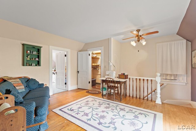3224 Sand Creek Highway, Adrian, MI 49221 - living area featuring wood-type flooring, vaulted ceiling, and a ceiling fan