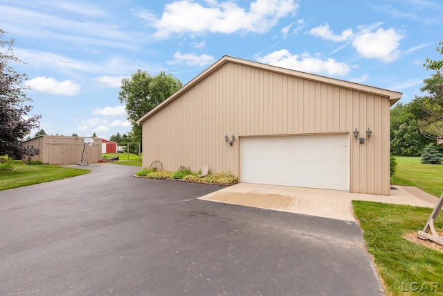 3224 Sand Creek Highway, Adrian, MI 49221 - view of side of property with a detached garage, an outbuilding, and a yard