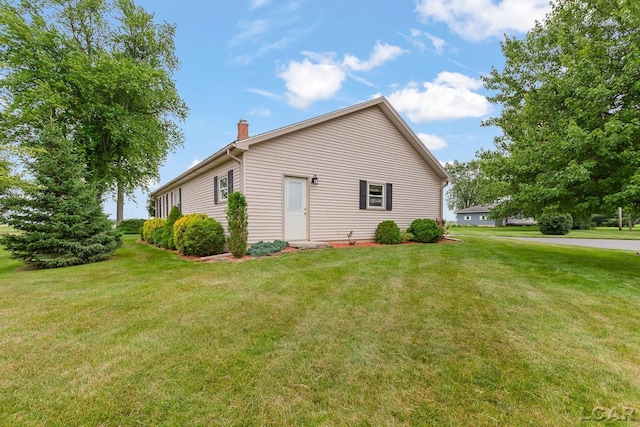 3224 Sand Creek Highway, Adrian, MI 49221 - view of home's exterior featuring a chimney and a yard