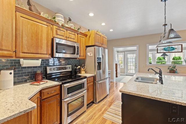 3224 Sand Creek Highway, Adrian, MI 49221 - kitchen with appliances with stainless steel finishes, decorative backsplash, light wood-style flooring, light stone counters, and recessed lighting