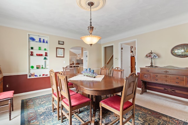 3224 Sand Creek Highway, Adrian, MI 49221 - carpeted dining space featuring arched walkways and built in shelves