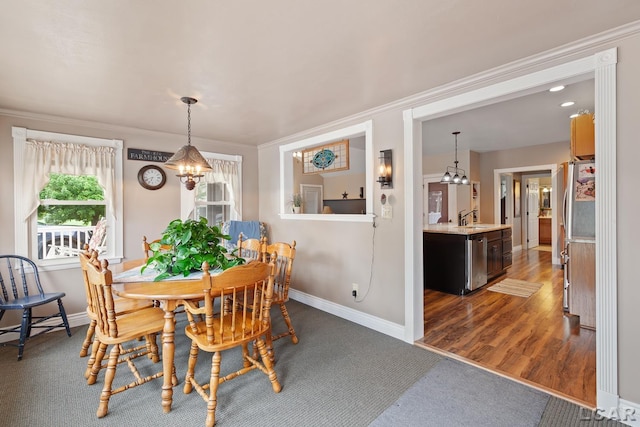 3224 Sand Creek Highway, Adrian, MI 49221 - dining room featuring a chandelier, ornamental molding, and dark colored carpet