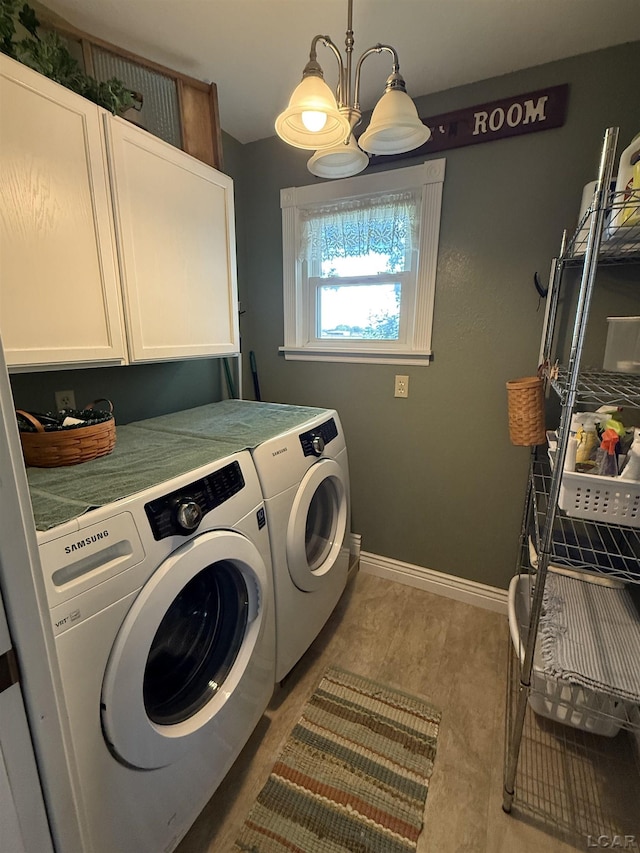 3224 Sand Creek Highway, Adrian, MI 49221 - laundry area featuring cabinet space, washing machine and clothes dryer, and a chandelier
