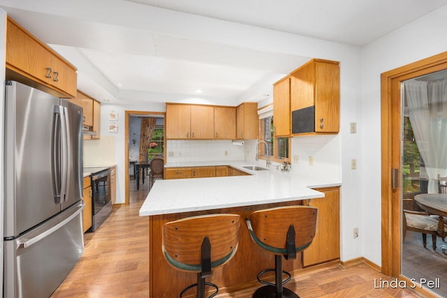 6636 E Riverwoods Ct NE, Rockford, MI 49341 - kitchen with freestanding refrigerator, stove, plenty of natural light, and recessed lighting