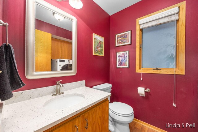 6636 E Riverwoods Ct NE, Rockford, MI 49341 - half bath featuring vanity and wood finished floors