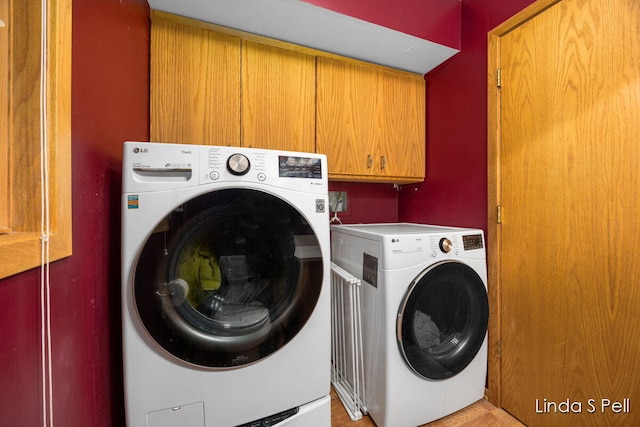 6636 E Riverwoods Ct NE, Rockford, MI 49341 - laundry area featuring washer and clothes dryer and cabinet space