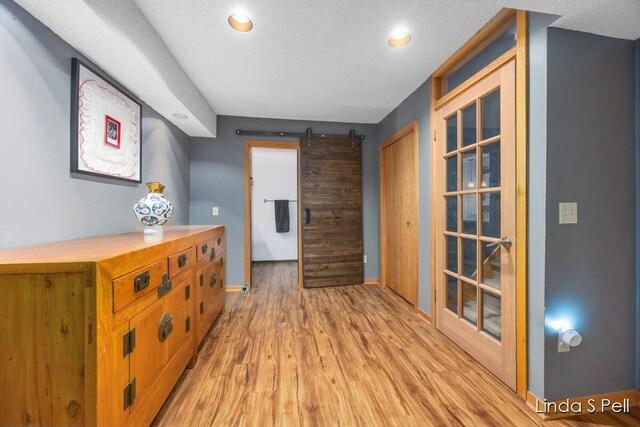 6636 E Riverwoods Ct NE, Rockford, MI 49341 - hallway featuring light wood-style floors and recessed lighting