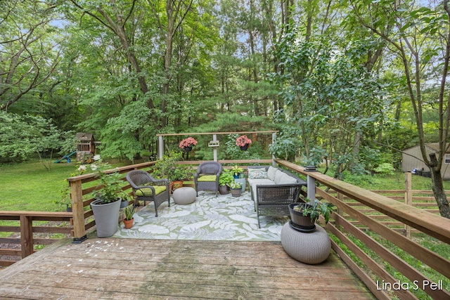 6636 E Riverwoods Ct NE, Rockford, MI 49341 - wooden deck featuring outdoor lounge area, a playground, and a yard