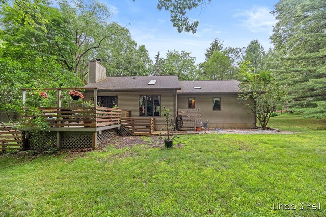 6636 E Riverwoods Ct NE, Rockford, MI 49341 - back of property featuring a yard, a chimney, a deck, and roof with shingles