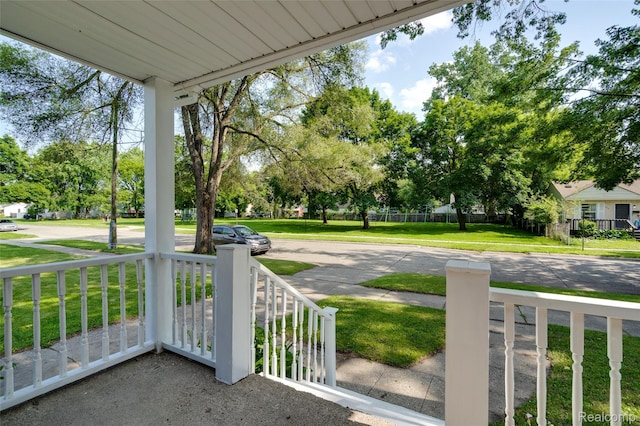 1217 E Madge Ave, Hazel Park, MI 48030 - covered porch featuring a lawn and view of scattered trees
