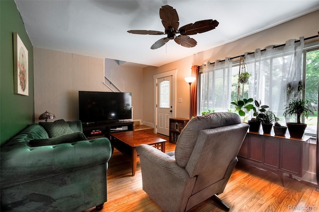 1217 E Madge Ave, Hazel Park, MI 48030 - living room featuring light wood-style floors, stairs, and a ceiling fan