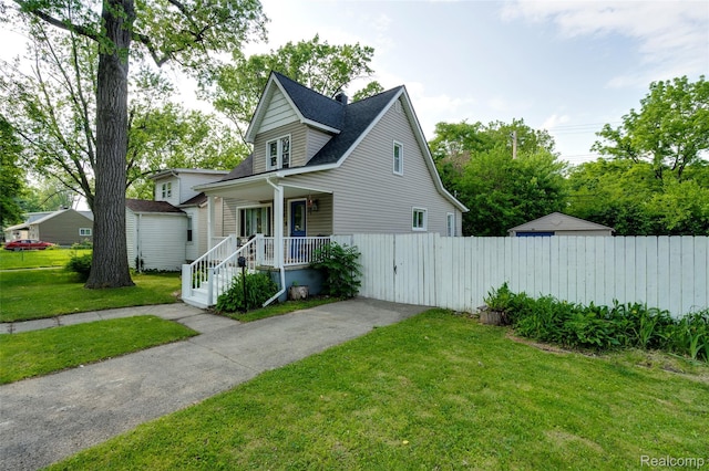 1217 E Madge Ave, Hazel Park, MI 48030 - view of front of property with covered porch, driveway, and a shingled roof