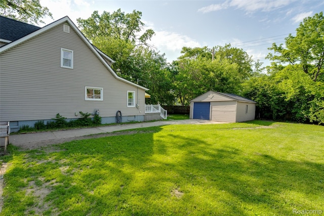 1217 E Madge Ave, Hazel Park, MI 48030 - view of green lawn with a garage and an outbuilding