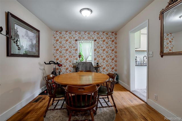 1217 E Madge Ave, Hazel Park, MI 48030 - dining area featuring light wood-style flooring and baseboards