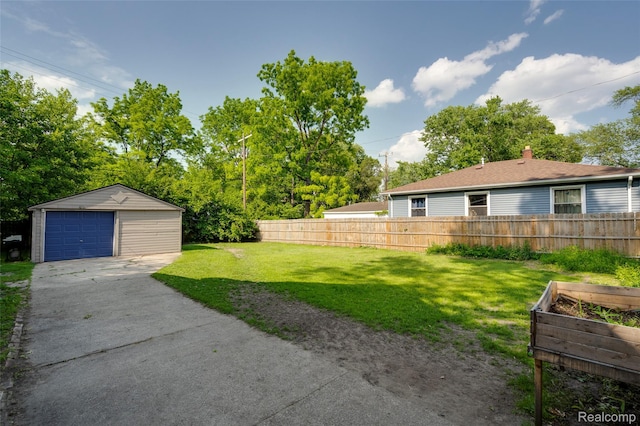 1217 E Madge Ave, Hazel Park, MI 48030 - view of yard featuring concrete driveway, an outdoor structure, a garage, and a vegetable garden