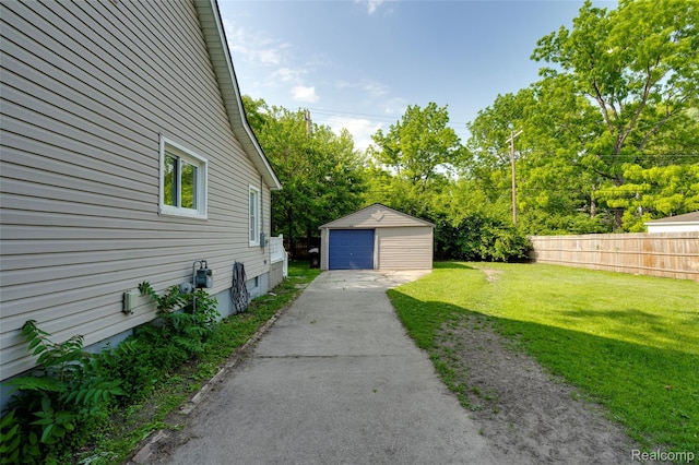 1217 E Madge Ave, Hazel Park, MI 48030 - view of yard with asphalt driveway, a detached garage, an outdoor structure, and view of wooded area