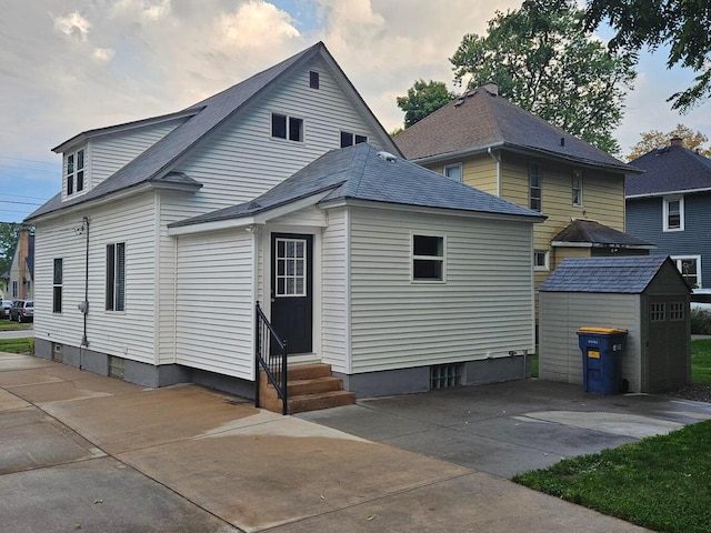 46 Lowell Ave NE, Grand Rapids, MI 49503 - rear view of house featuring entry steps, a storage shed, and a patio area