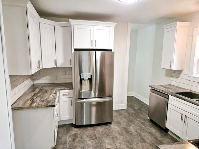 46 Lowell Ave NE, Grand Rapids, MI 49503 - kitchen with stainless steel appliances, white cabinetry, backsplash, and dark countertops
