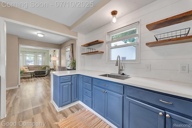 36149 Schley Ave, Van Buren, MI 48186 - kitchen featuring open shelves, blue cabinets, light wood-style flooring, and light countertops